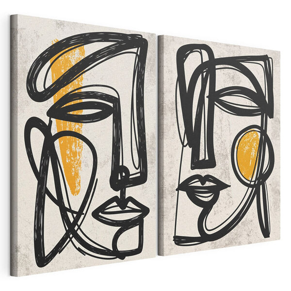Un paio di facce disegnate in nero e giallo Stampa su tela modulare Un paio di facce disegnate in nero e giallo